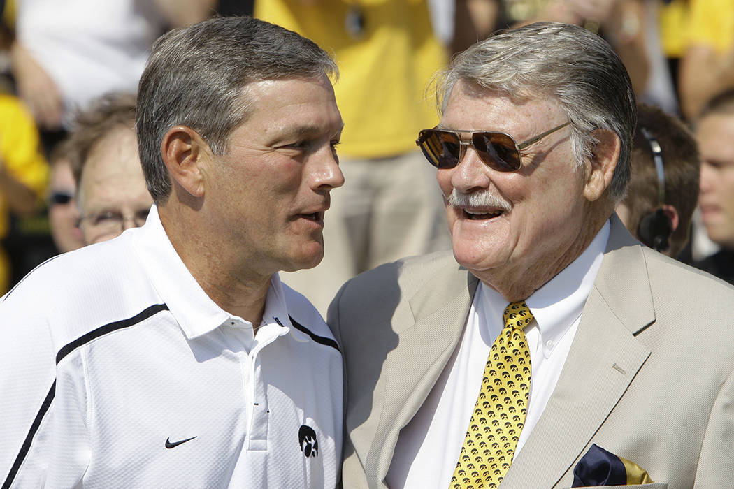 Iowa coach Kirk Ferentz, left, talks with former Iowa coach Hayden Fry before Iowa's NCAA colle ...