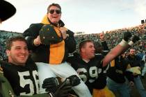 ** FILE ** Iowa football coach Hayden Fry is carried off the field after his team defeated Minn ...