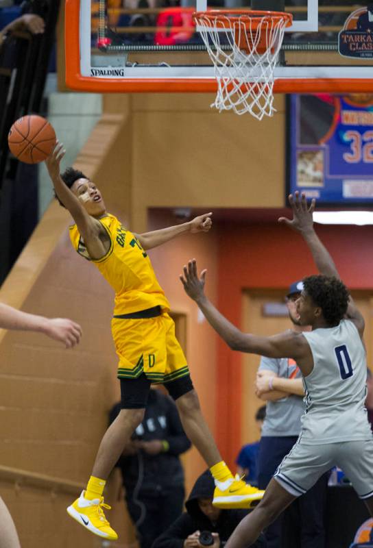 Oak Ridge sophomore guard Fabio Basili (30) fights for a loose ball with Sierra Canyon freshman ...