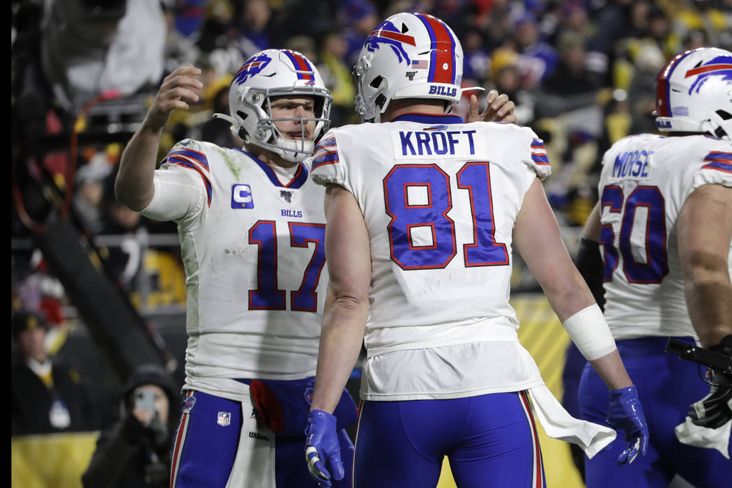 Buffalo Bills quarterback Josh Allen (17) celebrates after throwing a touchdown pass to tight e ...