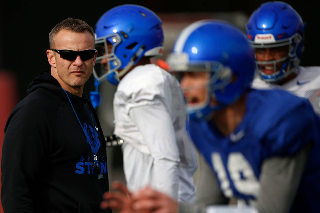 Boise State head coach Bryan Harsin, left, is seen during football practice in Las Vegas, Wedne ...