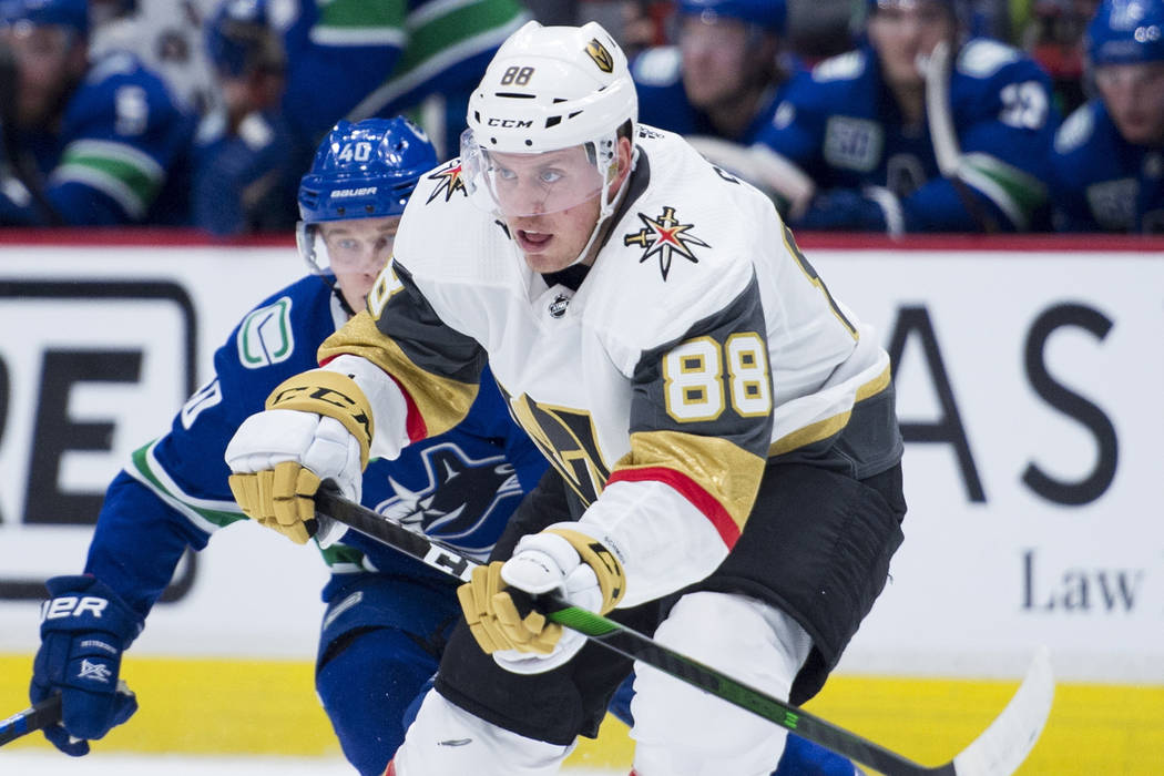 Vancouver Canucks center Elias Pettersson (40) chases Vegas Golden Knights defenseman Nate Schm ...