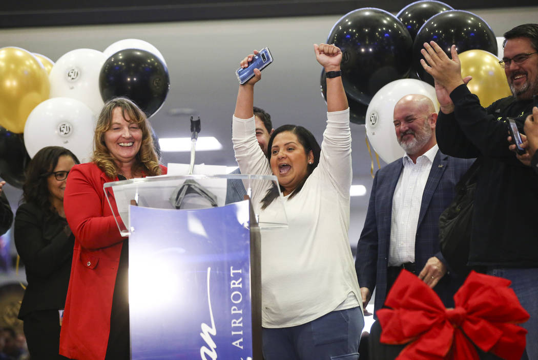 Hilda Black, of San Antonio, Texas, center, reacts after being designated as the 50 millionth p ...