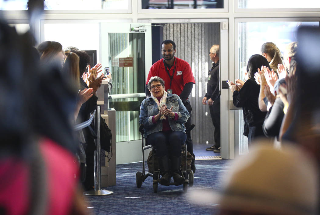 Passengers deplaning from an Allegiant flight from San Antonio are welcomed with cheers during ...