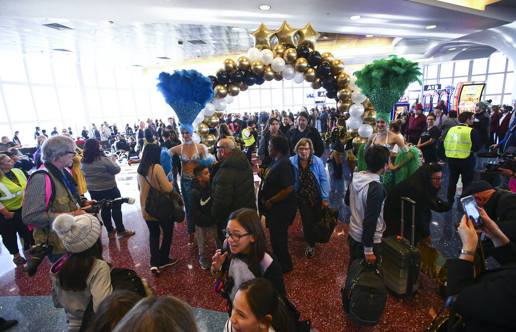 Passengers deplaning from an Allegiant flight from San Antonio are welcomed with fanfare during ...