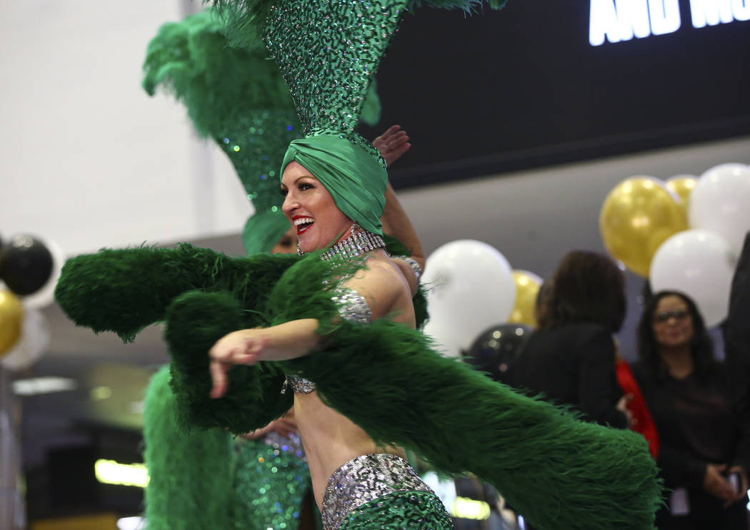 Showgirl Jennifer Vossmer performs during an event celebrating the 50 million passenger mark at ...
