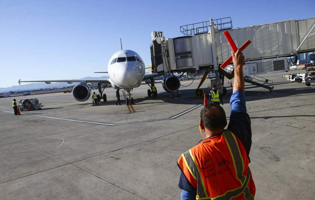 An Allegiant flight from San Antonio arrives at the gate after being welcomed with a water cann ...