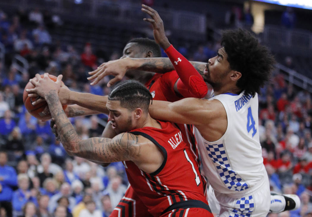 Kentucky's Nick Richards (4) fouls Utah's Timmy Allen (1) during the second half of an NCAA col ...
