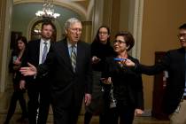 Senate Majority Leader Mitch McConnell, R-Ky., talks to reporters as leaves the senate chamber ...