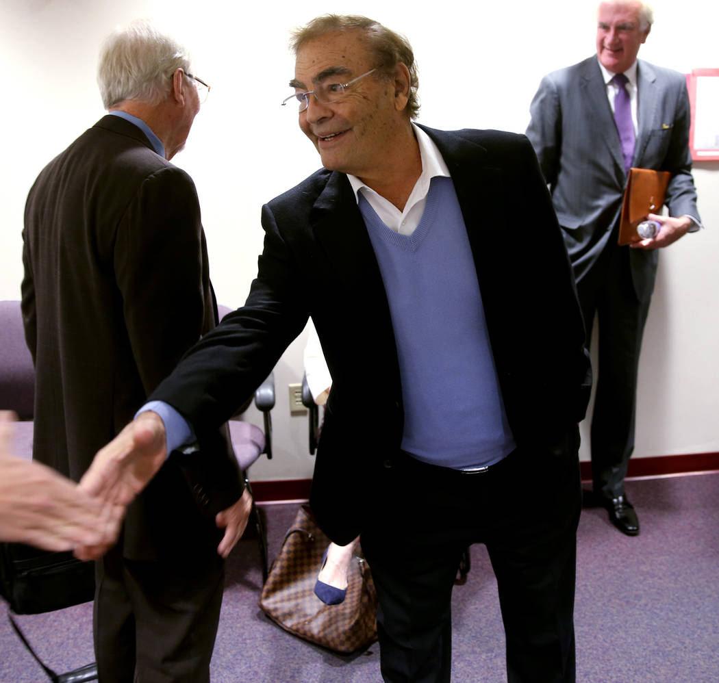 Phil Ruffin shakes hands with members of the news media while waiting to appear before Nevada G ...