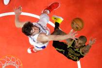 Los Angeles Lakers guard Gary Payton II, right, shoots as Los Angeles Clippers center Boban Mar ...