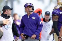 Washington head coach Chris Petersen looks on from the sidelines during an NCAA college footbal ...