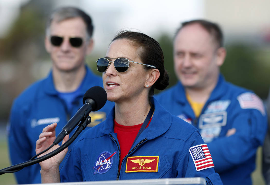 NASA astronaut Nicole Mann speaks as Boeing astronaut Chris Ferguson, left, and NASA astronaut ...