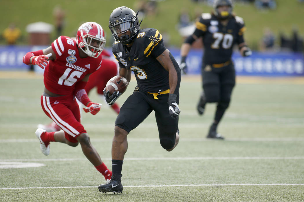 Appalachian State running back Darrynton Evans (3) evades Louisiana-Lafayette defensive back Pe ...