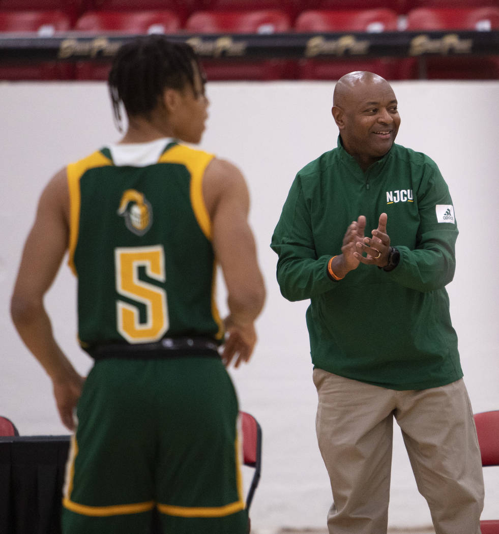 New Jersey City University's head coach Marc Brown claps after his team made a point during the ...