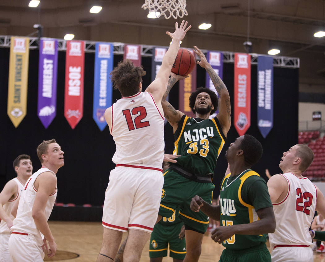 University of Wisconsin-River Falls' guard Keegan O'Neill (12) jumps to block New Jersey City U ...
