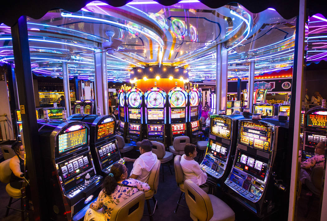 Hotel guests gamble on slot machines on a rotating surface at Circus Circus in Las Vegas, June ...