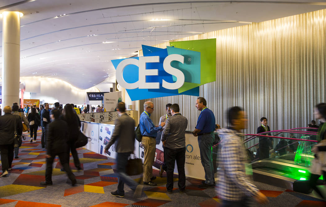 CES attendees make their way to the Sands Expo and Convention Center in Las Vegas on Wednesday, ...