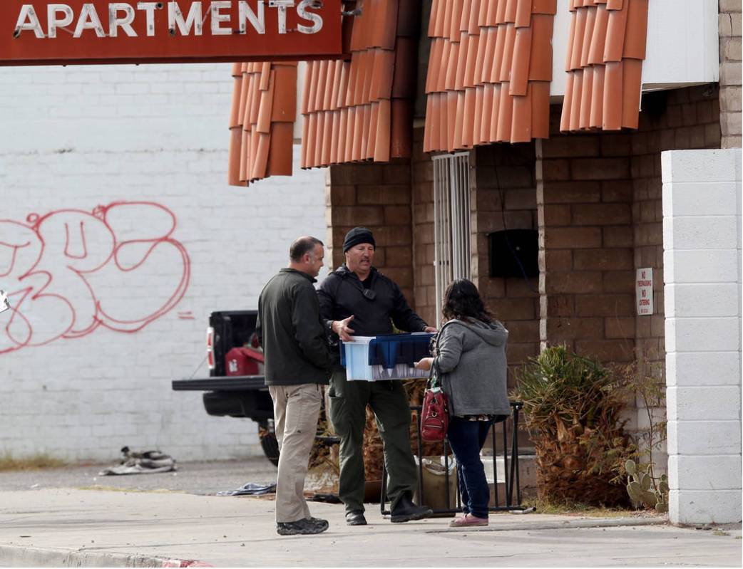 Fire officials talks to co-owner Malinda Mier, right, at Alpine Motel Apartments after a fire l ...