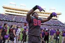TCU defensive end Adam Plant Jr. (98) celebrates in the bench area during the final seconds of ...