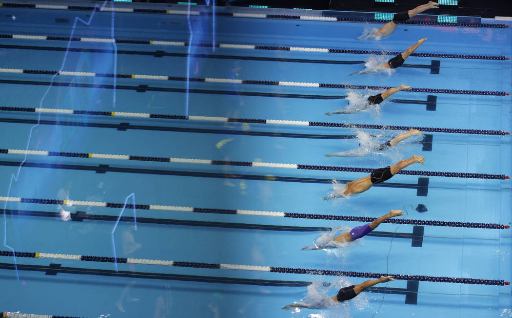 Swimmers compete in the mens's 4x100-meter freestyle relay during an International Swimming Lea ...