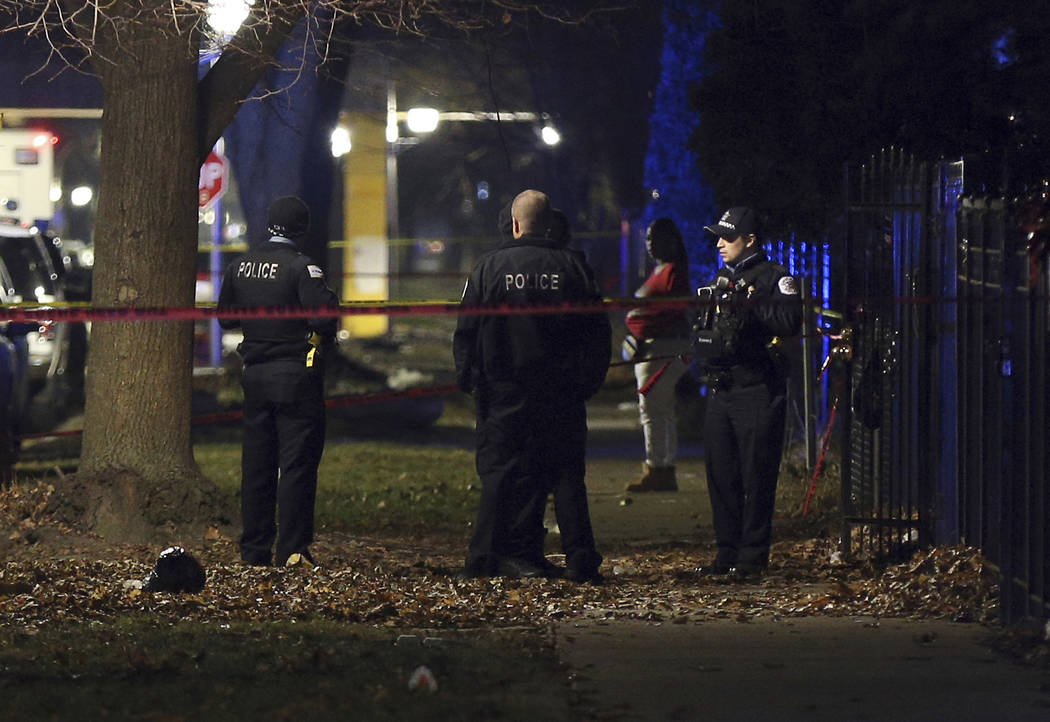 Chicago police guard a crime scene in the 5700 block of S. May Street in Chicago after several ...