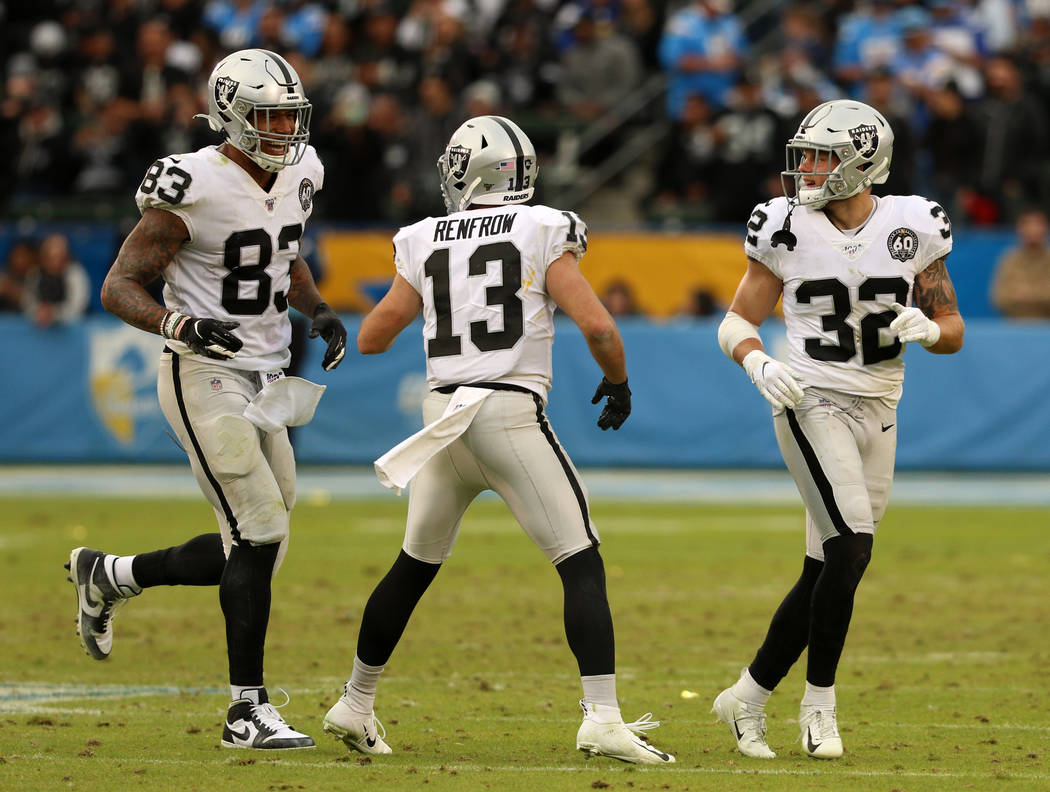 Oakland Raiders wide receiver Hunter Renfrow (13) and defensive back Dallin Leavitt (32) celebr ...