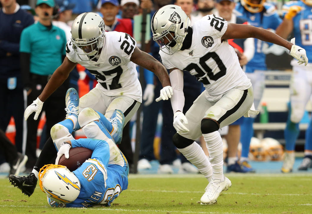 Oakland Raiders cornerback Trayvon Mullen (27) and cornerback Daryl Worley (20) tackle Los Ange ...