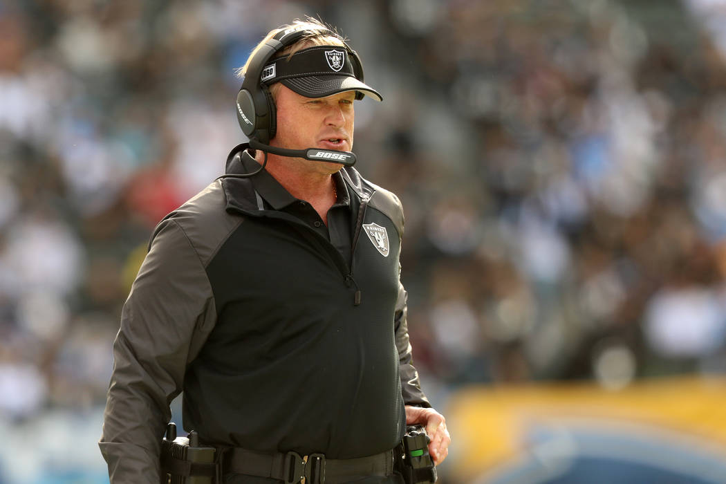 Oakland Raiders head coach Jon Gruden walks the sideline during the first half of an NFL game a ...