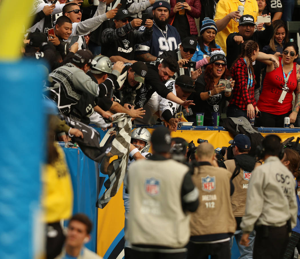 Oakland Raiders quarterback Derek Carr (4) celebrates his touchdown as the crowd cheers during ...