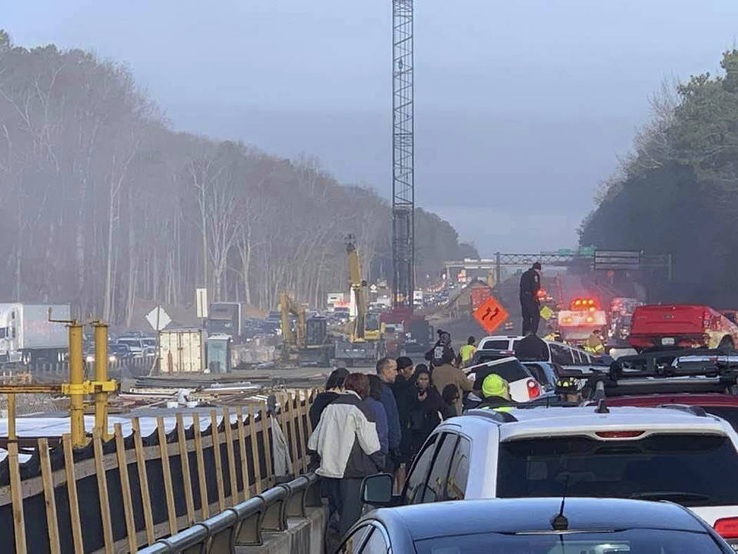 Drivers and emergency personnel remain on the scene of a multi-vehicle pileup on Interstate 64 ...