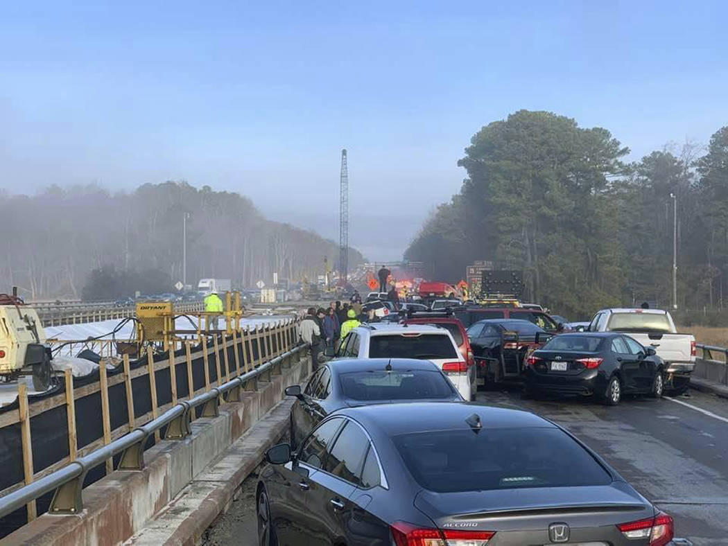 Drivers and emergency personnel remain on the scene of a multi-vehicle pileup on Interstate 64 ...
