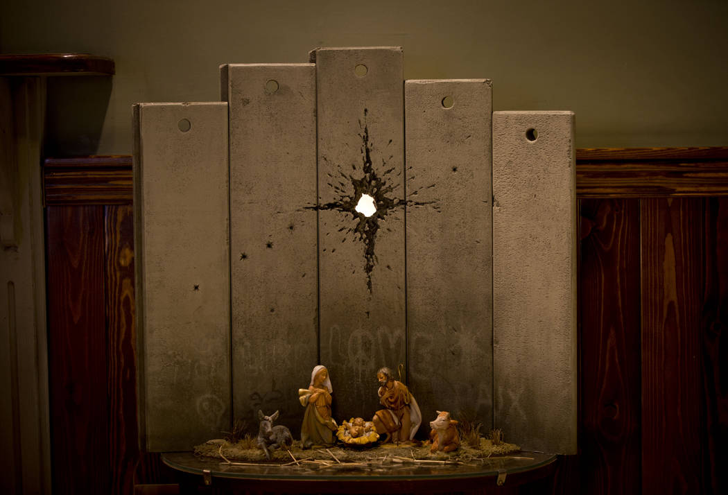 A new artwork dubbed "Scar of Bethlehem" by the artist Banksy is displayed in The Wal ...