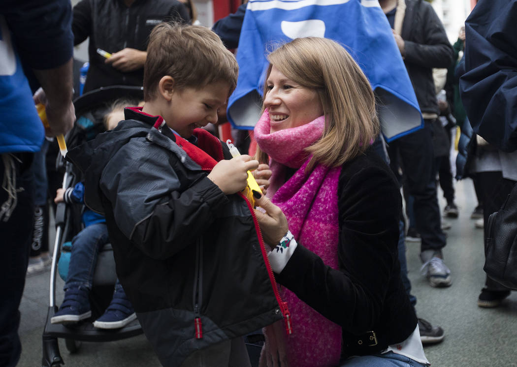 Lena Levy breaks a glowstick with her son Jacob Levy, 5, at a menorah lighting hosted by Chabad ...