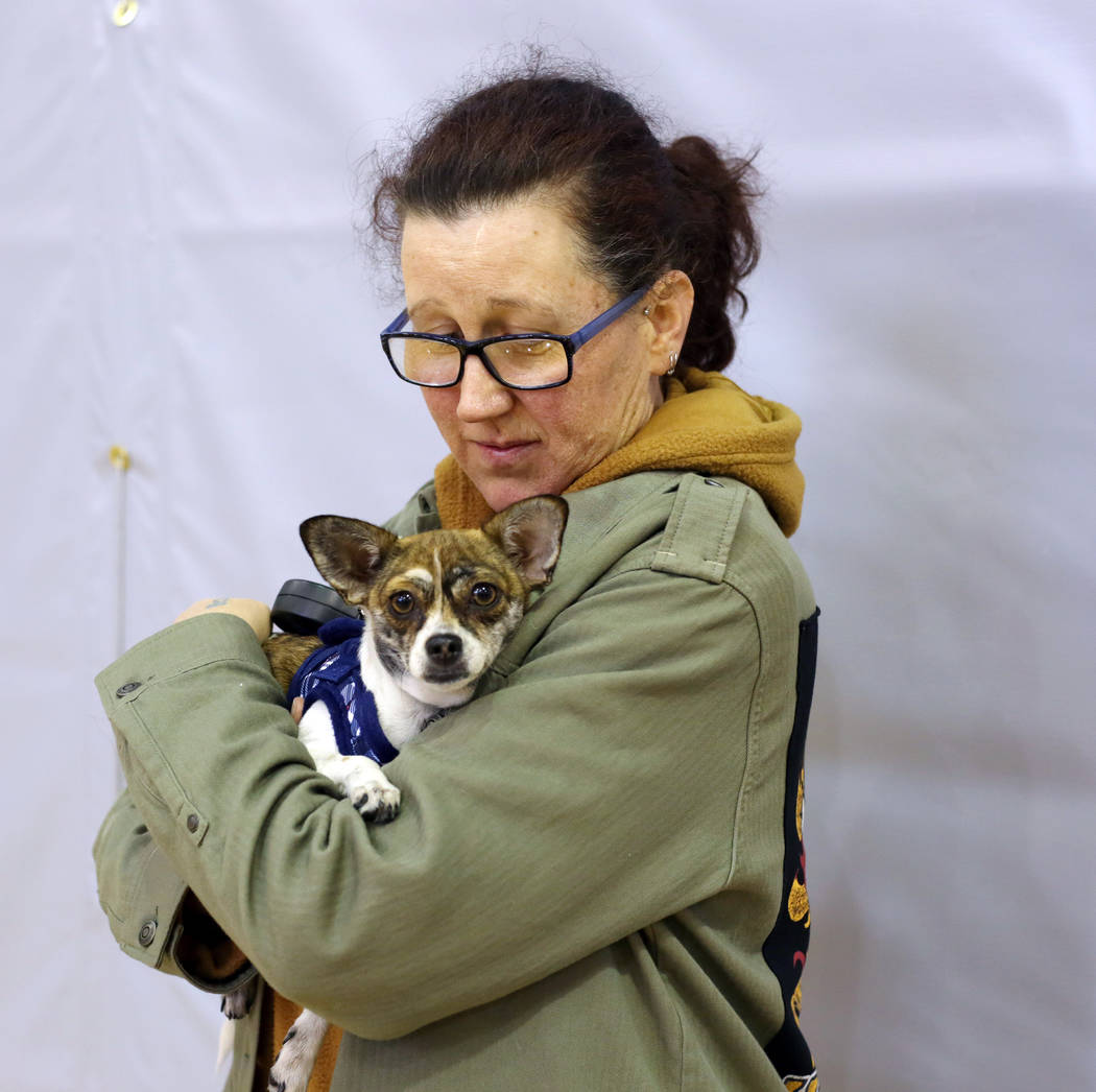 Alpine Motel Apartments resident Christina Farinella holds her dog Baby while Farinella checks ...