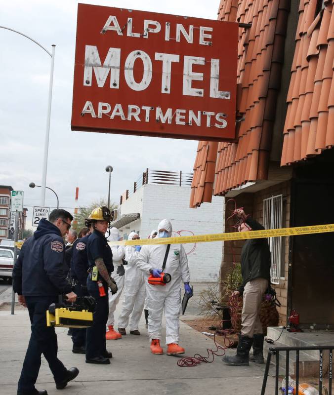 Las Vegas Fire Department investigators with assistance from Las Vegas police enter the Alpine ...