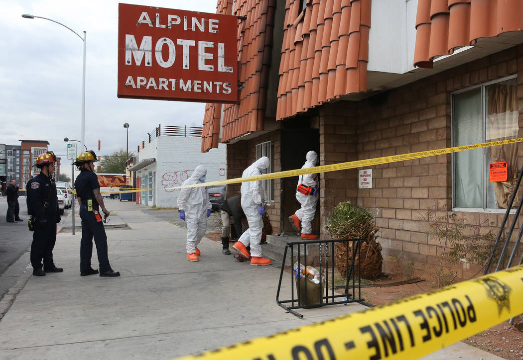 Las Vegas Fire Department investigators with assistance from Las Vegas police enter the Alpine ...