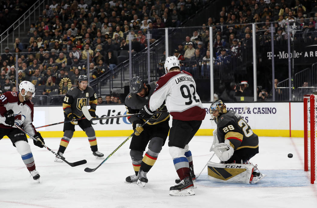 Colorado Avalanche center Nazem Kadri (91) scores past Vegas Golden Knights goaltender Marc-And ...