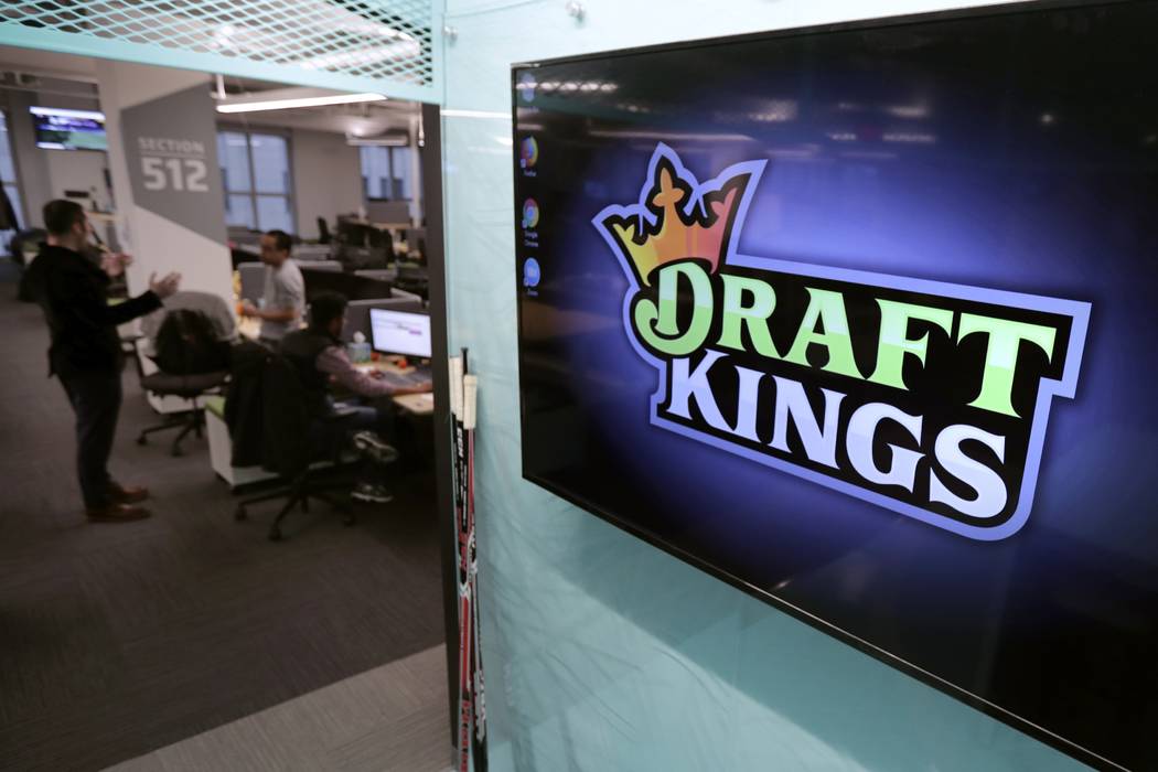 FILE - In this May 2, 2019, file photo, the DraftKings logo is displayed at the sports betting ...