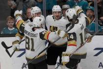 Vegas Golden Knights defenseman Shea Theodore, center, is congratulated by teammates after scor ...