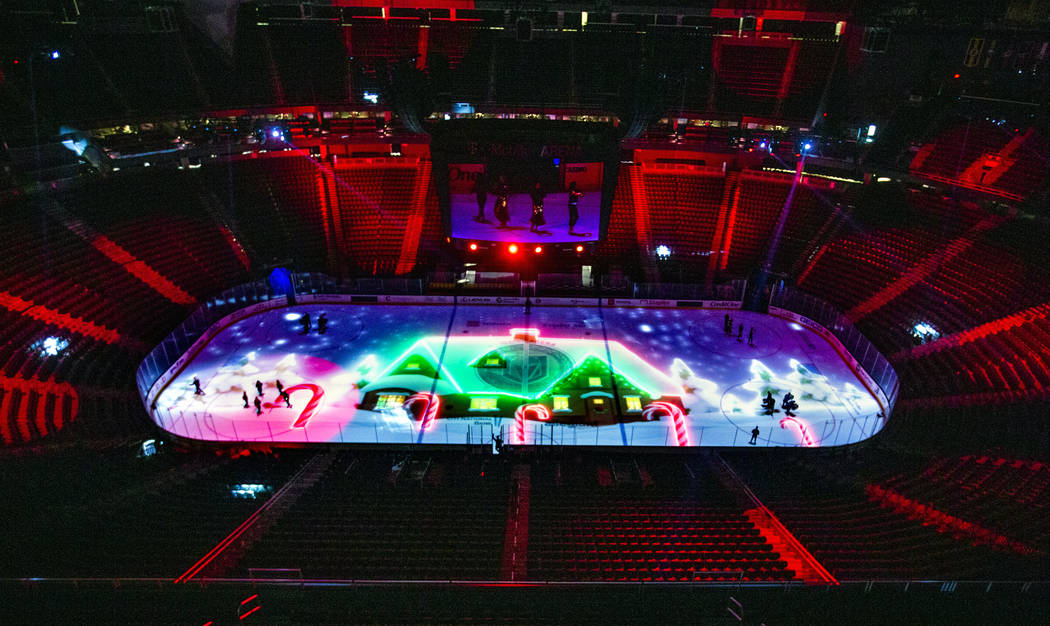 A snowy scene is projected onto the ice during a rehearsal for the Vegas Golden Knights holiday ...