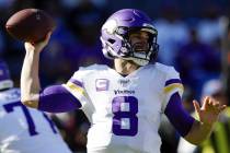 Minnesota Vikings quarterback Kirk Cousins throws a pass during the first half of an NFL footba ...