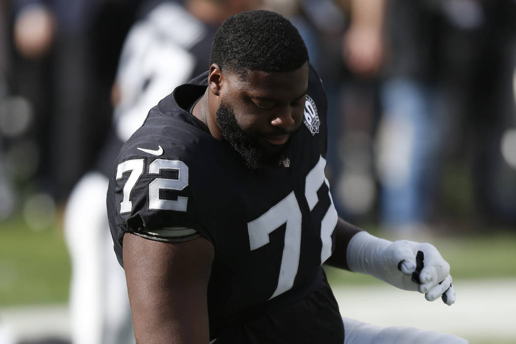 Oakland Raiders offensive tackle David Sharpe warms up before an NFL football game against the ...