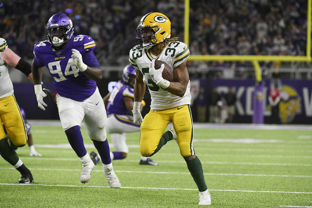 Green Bay Packers running back Aaron Jones (33) scores on a 56-yard touchdown run during the se ...