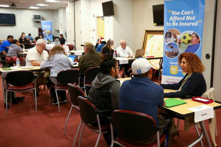 Insurance broker Jeanna Kamo, right, helps a couple sign up for the exchange during an open enr ...