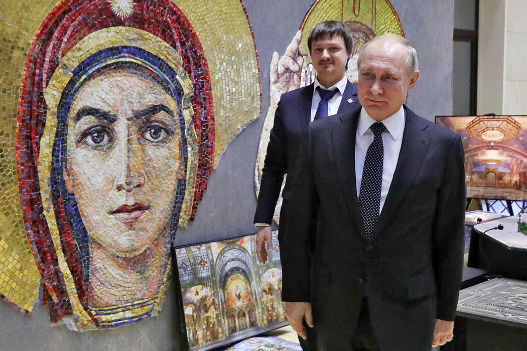 Russian President Vladimir Putin visits an exhibition ahead of an annual meeting with top milit ...