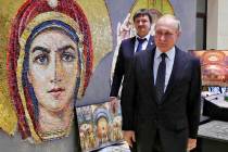 Russian President Vladimir Putin visits an exhibition ahead of an annual meeting with top milit ...