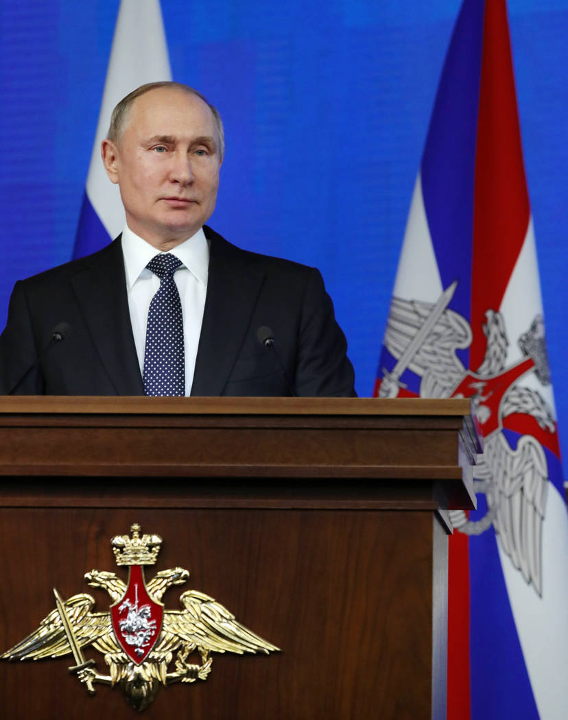 Russian President Vladimir Putin delivers his speech during an annual meeting with top military ...