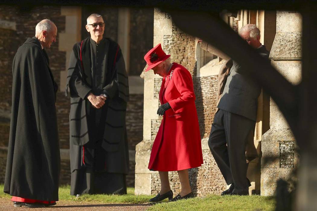 Britain's Queen Elizabeth II arrives to attend the Christmas day service at St Mary Magdalene C ...