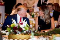 President Donald Trump and first lady Melania Trump talk at Mar-a-lago while there for Christma ...